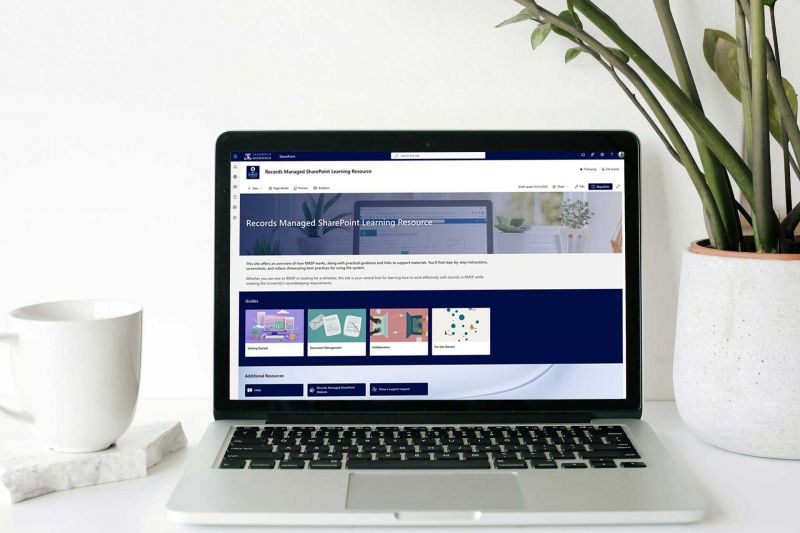 Laptop on a desk displaying the homepage of the resource