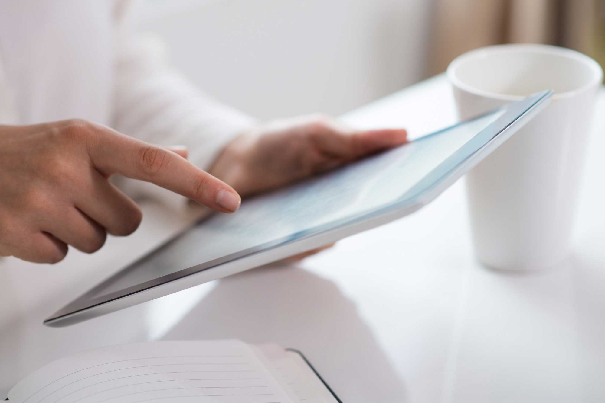 Hand touching a tablet