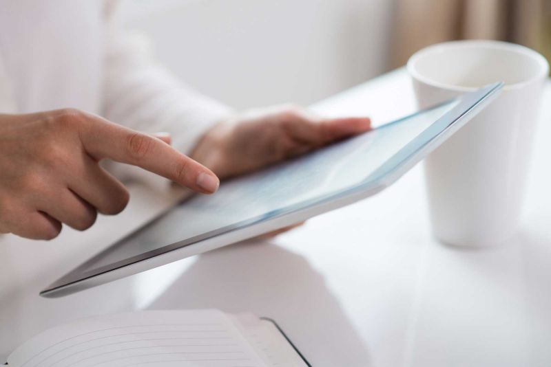 Hand touching a tablet