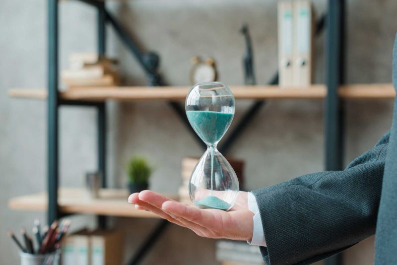 Hand holding an hourglass